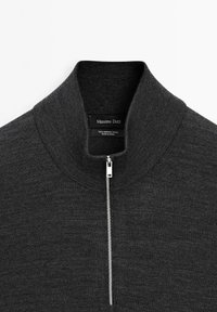 Dark gray merino wool sweater featuring a high collar and a front zipper. The fabric is smooth with a fine texture. Brand label visible inside.