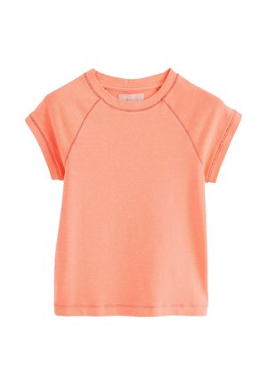 T-shirt à manches courtes, couleur corail, avec un col arrondi et des manches raglan, fabriqué en tissu léger, présentant une texture subtile et des détails de couture.