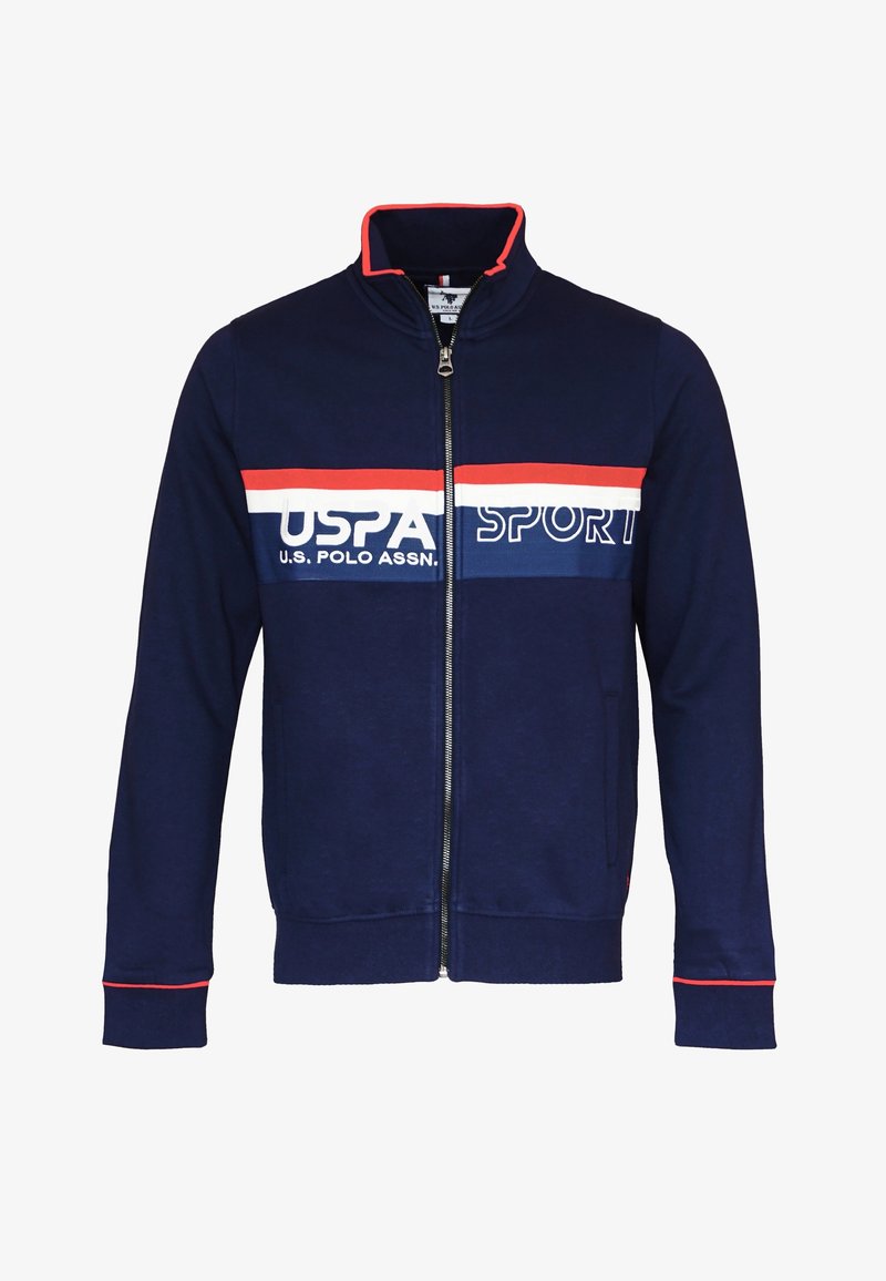 Veste zippée marine avec rayures horizontales rouges et blanches. Comprend un logo U.S. Polo Assn., des poches latérales, ainsi que des poignets et un col côtelés.