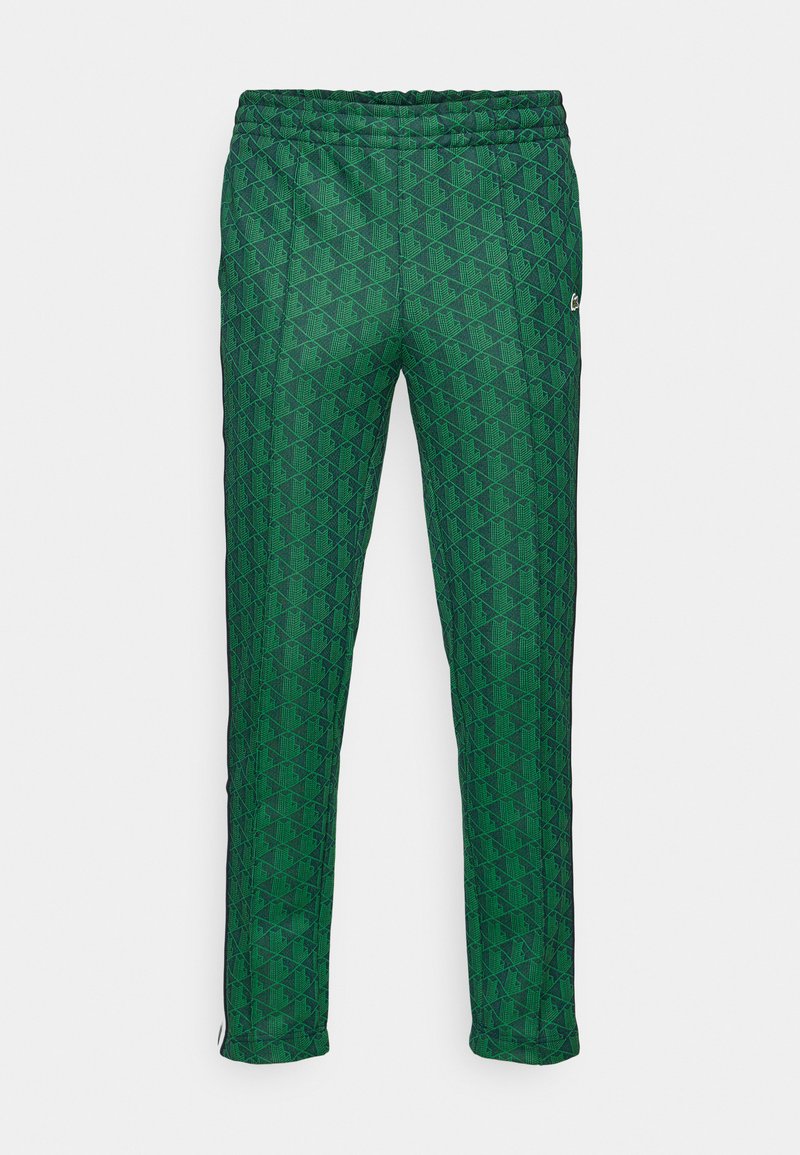 Grüne Jogginghosen mit geometrischem Muster, elastischem Bund und schmaler Passform mit kontrastierenden Seitenelementen.