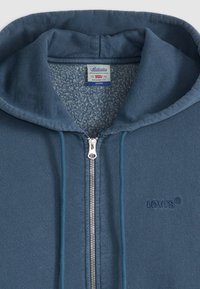 Blå Levi's zip-up hettegenser med hette, snor, fleeceforing og brodert logo på brystet.
