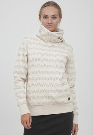 Pullover color crema con colletto alto, caratterizzato da un motivo a onde e tre bottoni marroni laterali. Texture in maglia morbida, vestibilità comoda.