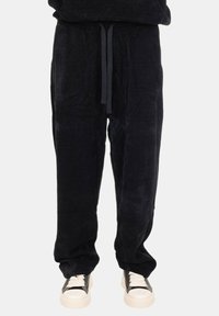 Pantaloni della tuta neri in corduroy con vita elastica e lacci regolabili, caratterizzati da una vestibilità comoda e una consistenza morbida.