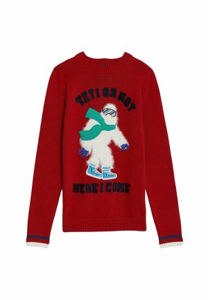 Rode gebreide trui met een witte yeti die blauwe sneakers, een groene sjaal en een bril draagt, met de tekst "YETI OR NOT HERE I COME."