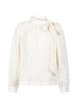 Witte kantblouse met lange mouwen, bloemmotief, hoge halslijn en een strik aan de rechter schouder.