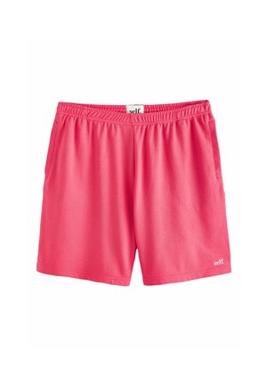 Knallpinke Sportshorts mit elastischem Bund und Seitentaschen, mit kleinem "self."-Logo am unteren rechten Saum.