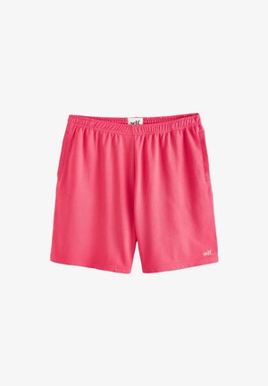 Pantaloncini sportivi rosa acceso con vita elasticizzata e tasche laterali, con piccolo logo "self." sull'orlo in basso a destra.