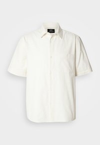 Lyhythihainen napillinen paita off-white-kankaasta, vasemmassa rinnassa tasku ja klassinen kaulustyyppi. Sileä pinta.