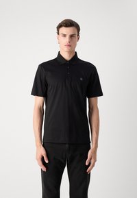 Black short-sleeve polo shirt with a collar, featuring three buttons and a small logo on the chest. Made of smooth fabric.