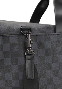 Czarna skórzana torba w kratę o matowej fakturze, z błyszczącym srebrnym metalowym klipsem i płaskim czarnym skórzanym paskiem.