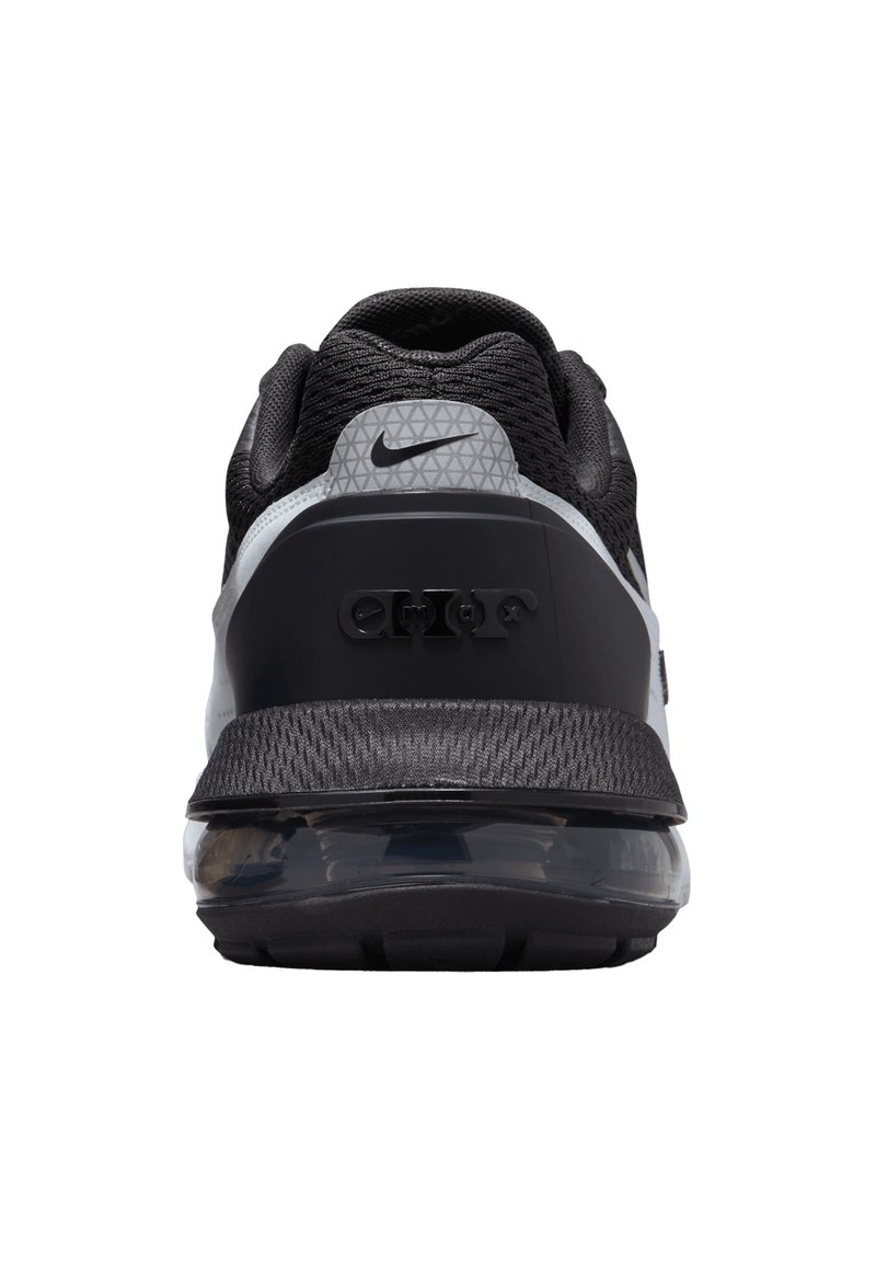 Sneaker atletica nera e grigia con tomaia in mesh testurizzato, suola in gomma e dettaglio di cuscino d'aria trasparente nel tallone. Logo Nike sul tallone.