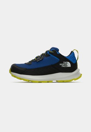Blue and black athletic shoes with a mesh upper, yellow accents, rubber sole, and laces. Features "The North Face" logo on the heel.