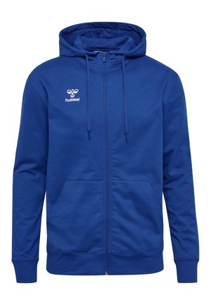 Niebieska bluza z kapturem na zamek, kieszeniami z przodu, kapturem ze sznurkiem oraz małym białym logo Hummel po lewej stronie klatki piersiowej.