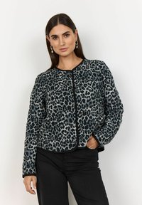Leopard print jacket featuring a textured, soft fabric, round neckline, and front snap closure, with contrasting black trim and long sleeves.