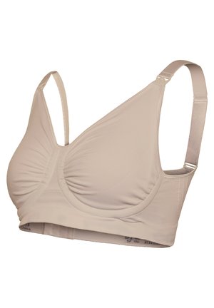 Beige trådløs bh lavet af glat stof, med samlingdetaljer, justerbare stropper og et bånd med diskret branding langs bunden.