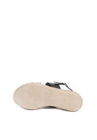 Infradito neri con una tomaia texture e una cintura con fibbia. La suola è beige con un motivo intrecciato lungo il bordo, che offre grip.