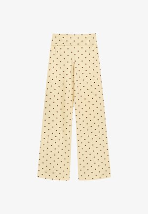 Pantalones crema de cintura alta y pierna ancha con pequeños lunares marrones distribuidos de manera uniforme, exhibidos sobre un fondo blanco.