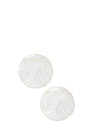 Two round white ceramic plates with raised pumpkin designs and vine details around the edges.