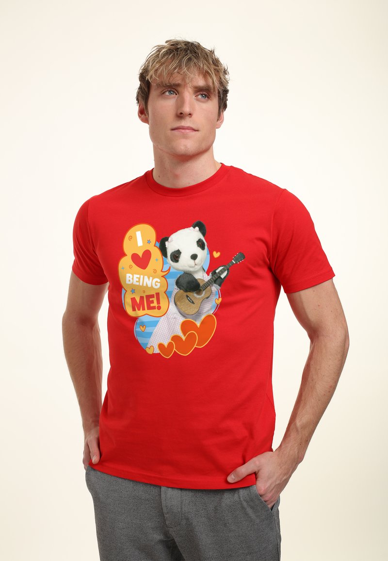 Red cotton T-shirt featuring a graphic design of a panda with a guitar, surrounded by hearts and colorful text saying "I ❤️ BEING ME!"