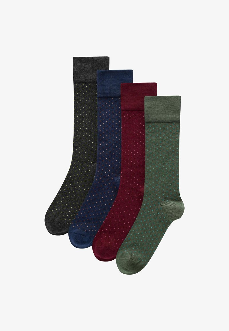 Quatre paires de chaussettes en gris foncé, marine, bordeaux et vert, chacune avec un motif à pois subtil et des revers de couleur contrastante.