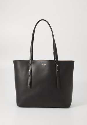 Black leather tote bag with two long handles, minimalist design, seamless body, featuring subtle gold hardware and embossed logo detail.