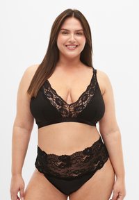 Black bralette and high-waisted panties featuring floral lace trim. The bralette has a V-neck design with adjustable straps.