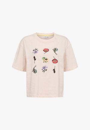 Jasnobeżowa koszulka z krótkim rękawem z haftowanymi kwiatowymi wzorami ułożonymi na froncie w siatkę 3 na 3.