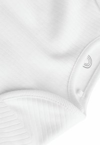 Bodysuit en tissu côtelé blanc avec une texture lisse, présentant un col rond et une petite étiquette logo près de l'ourlet.
