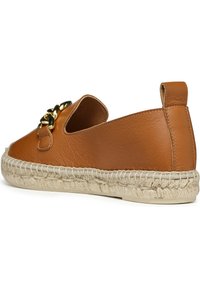 Tan leather espadrille slip-on shoe with natural jute sole, featuring a decorative gold chain accent on the side.
