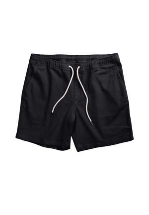 Svarte shorts laget av lett stoff, med elastisk midje og hvit snor. Innside og sidelommer er til stede.