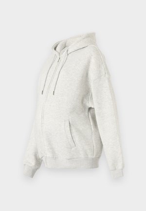 Light gray hoodie made of soft fabric. Features a front zipper, large pockets, and a drawstring adjustable hood. Loose-fit design.