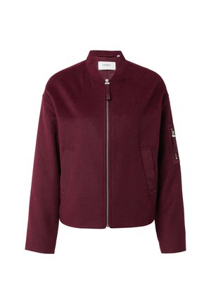 Burgundy fleece bomber jacket with a front zip closure, side pockets, and a zippered pocket on the sleeve. Features a round neck design.