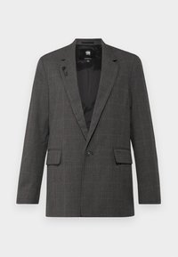 Grå rutete blazer med notklipperlapel, enkel knappelukking, to frontlommer og strukturert fôr. Akkompagnert av subtile pinstripe-mønstre.