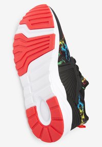 Svart sportskor med ett flerfärgat mönstrat ovandel och en tjock vit sula med röd accent och texturerat mönster.