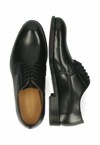 Scarpe eleganti in pelle nera con finitura liscia, punta tondeggiante, design con lacci e una robusta suola in gomma nera. Nome del brand impresso all'interno.