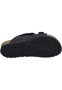 Black slip-on sandal with textured rubber sole, cork footbed, and adjustable straps. Features a smooth upper surface with minimal detailing.
