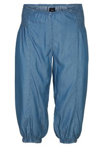 Siniset farkkukävelykengät, joissa on joustava vyötärö ja kerätty hihansuu. Pehmeä rakenne, löysä istuvuus ja kapeneva muoto antavat rennon tyylin.