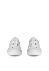 Coppia di sneakers bianche basse con lacci, punte arrotondate e suole in gomma testurizzata, viste frontalmente su uno sfondo bianco.