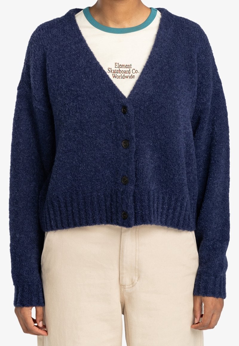 Mörkblå, mjuk kofta med V-ringning, långa ärmar och sex svarta knappar framtill. Ribbad fåll och ärmslut; kort modell.