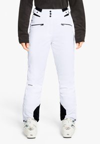 Weiße Skihosen mit schwarzen Akzenten, Reißverschlusstaschen, einem hohen Bund und Knopfverschluss. Hergestellt aus strapazierfähigem, wetterfestem Material.