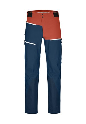 Waterproof cargo pants with a red and navy color scheme. Features multiple pockets, contrasting panels, white accents, and durable material.