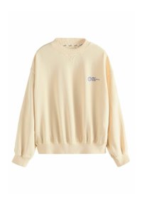 Felpa color crema con scollo a V, polsini a costine e vita elastica. Presenta testo blu che recita "SELF ATHLETICS CLUB" sul davanti.