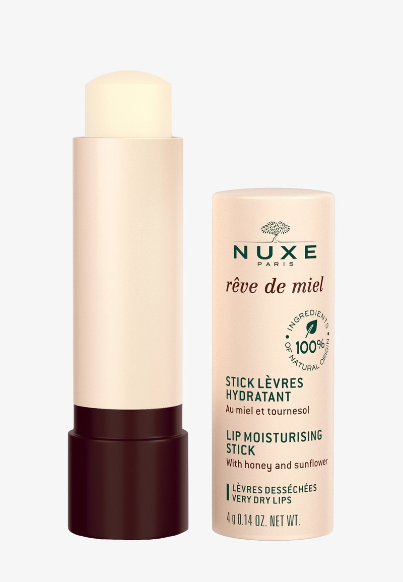 Balsam do ust w kremowym, cylindrycznym opakowaniu z ciemnobrązową podstawą. W komplecie z jasnoróżową pokrywką z etykietą.