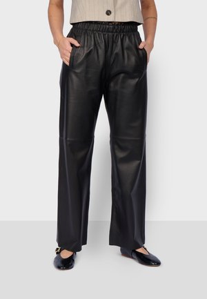 URANUS - Leather trousers - black
