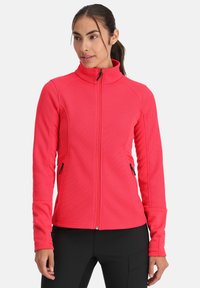 Felle roze ritsjack met ribbeltextuur, hoge kraag en zijzakken. Lange mouwen met contrasterende gladde stof bij de manchetten.