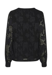 Blouse noire transparente à manches longues avec motif floral brodé et poignets boutonnés, vue de dos.