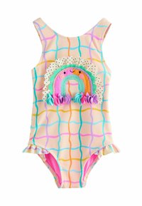 Traje de baño con un fondo durazno texturizado, patrón de cuadrícula colorido y un aplique de arcoíris con volantes y lunares a lo largo del escote.