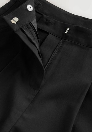 Pantalons noirs avec fermeture éclair, bouton et crochet, et une texture de tissu lisse avec une coupe ajustée.