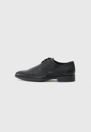 Black leather men's lace-up dress shoe with low stacked heel, rounded toe, and textured side panels on light grey background.