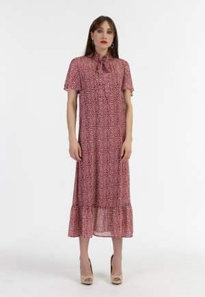 Punainen midi-mekko, jossa on valkoinen kukkakuvio, lyhyet hihat, sidottava kaula-aukko ja kerroksellinen helma. Valmistettu kevyestä kankaasta, jonka rakenne on ilmava.